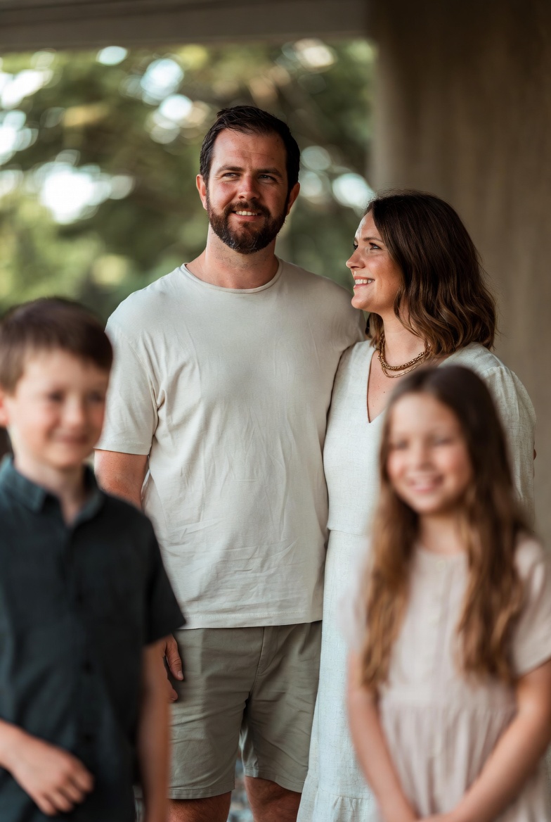 A family of four, smiling together